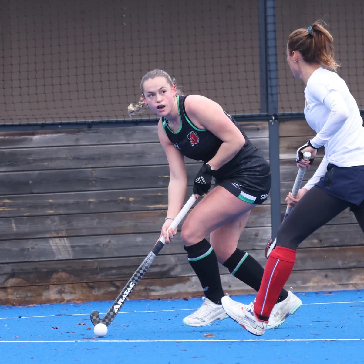 Aratac athlete controlling the ball during a competitive hockey match