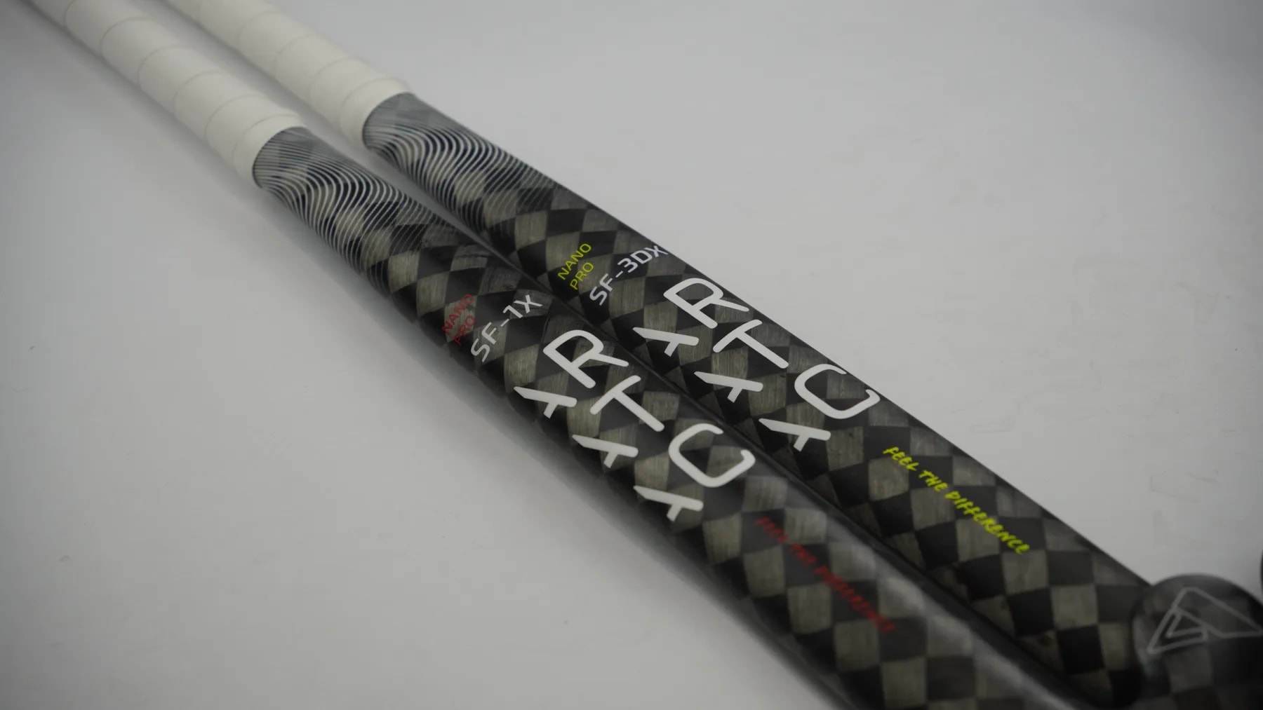 Two Aratac Nano Pro hockey sticks showing their carbon-fibre construction