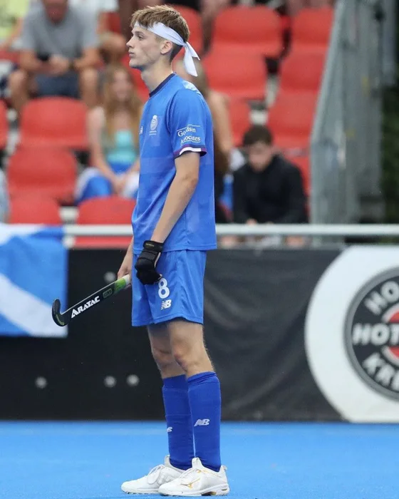 Henry Porter standing pitchside with his Aratac hockey stick.