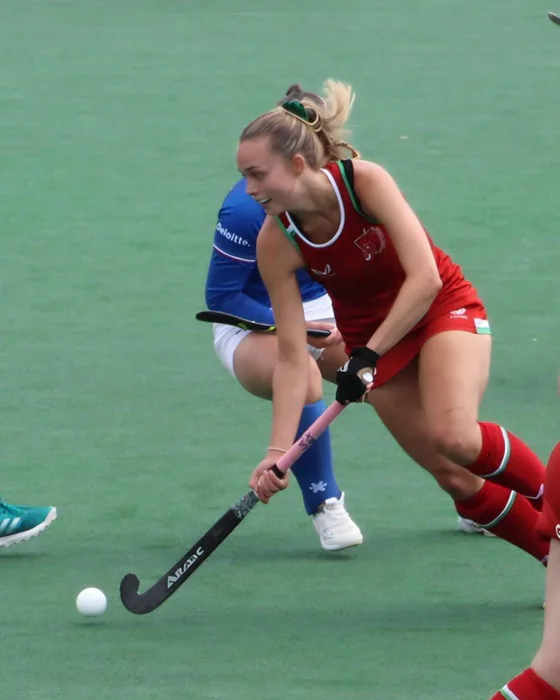 Katie Partridge controlling the ball for Wales during a hockey match.